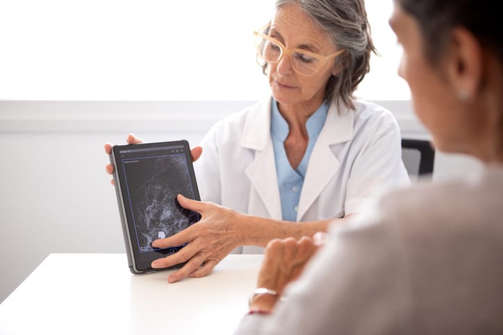 Photo shows a gynecologist discussing test outcomes with a female patient/Getty Images