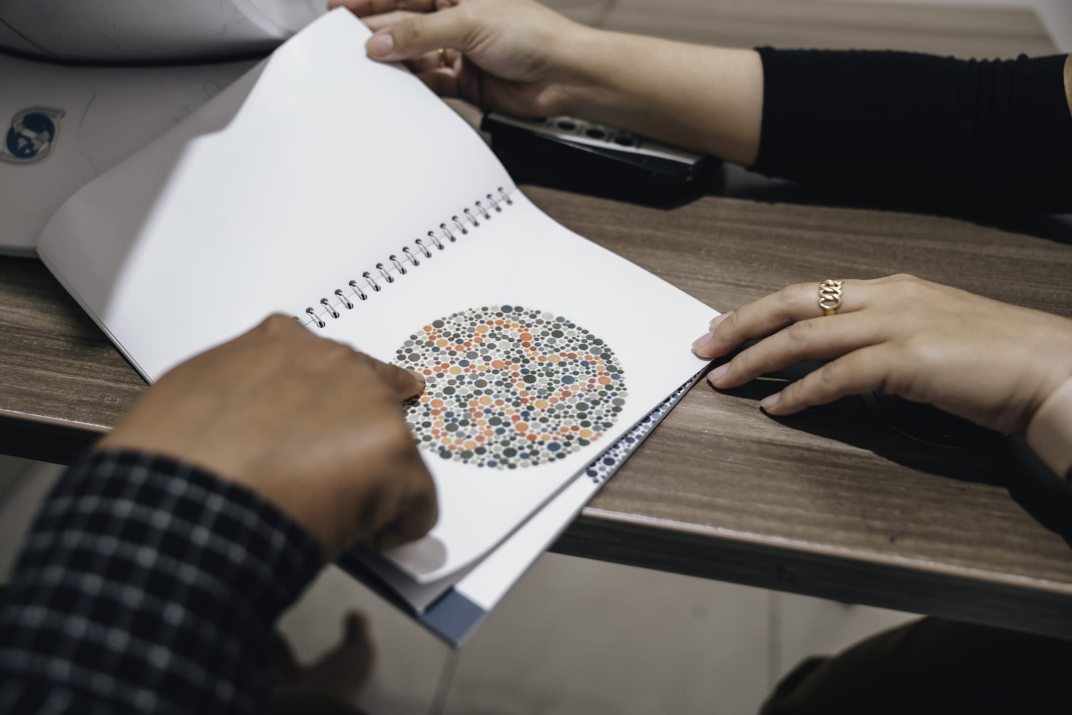 eye doctor measuring color blindness to patient