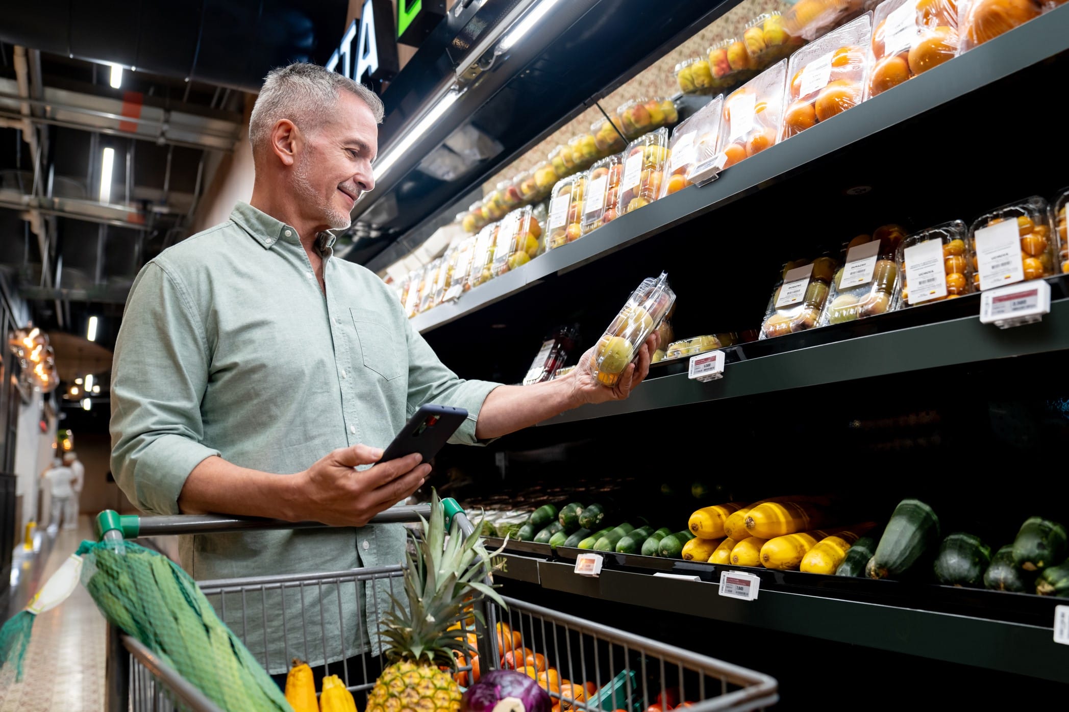 Man in grocery store looking at nutrition label