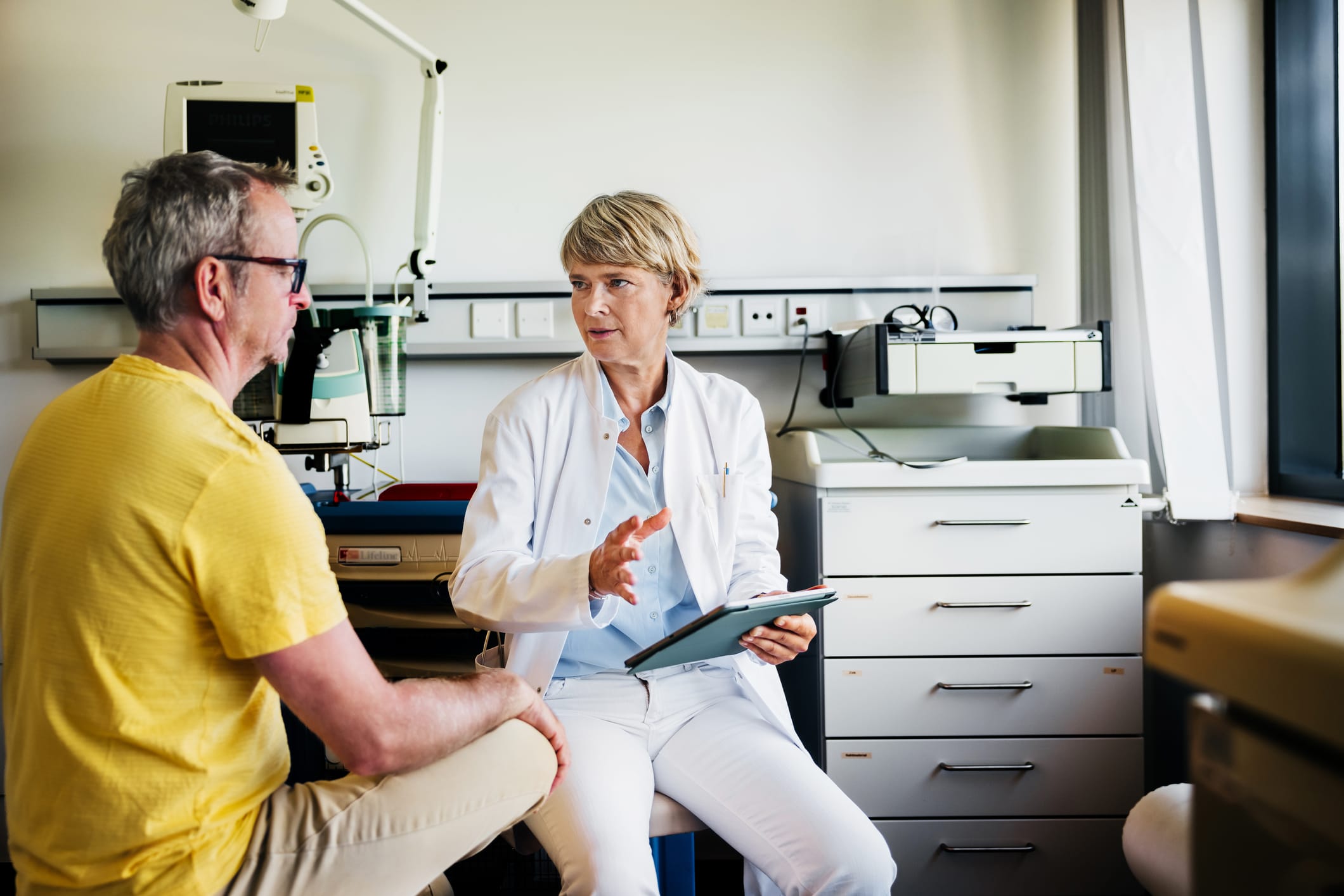 A doctor showing information to a male patient