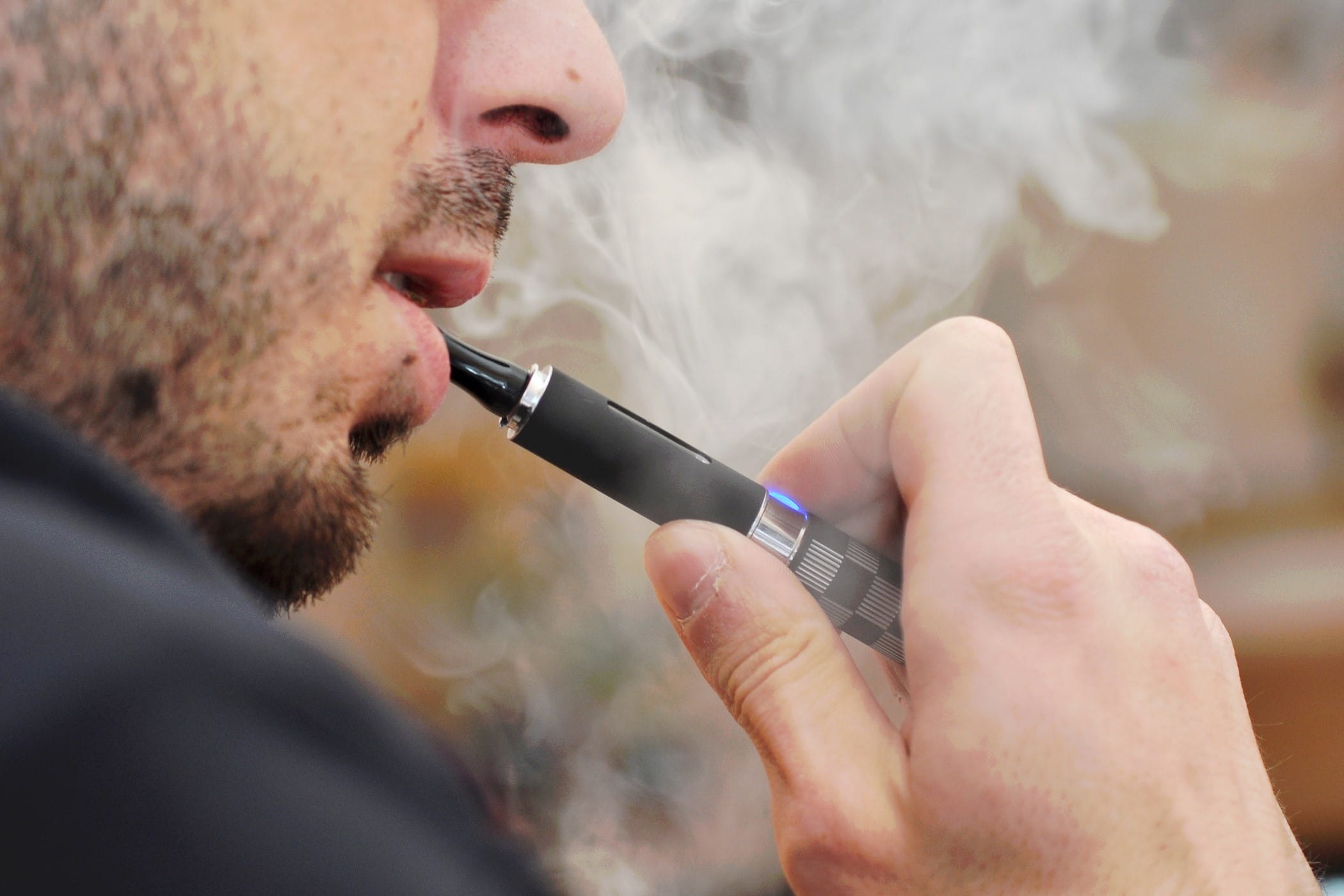 Close-up of man smoking an e-cigarette