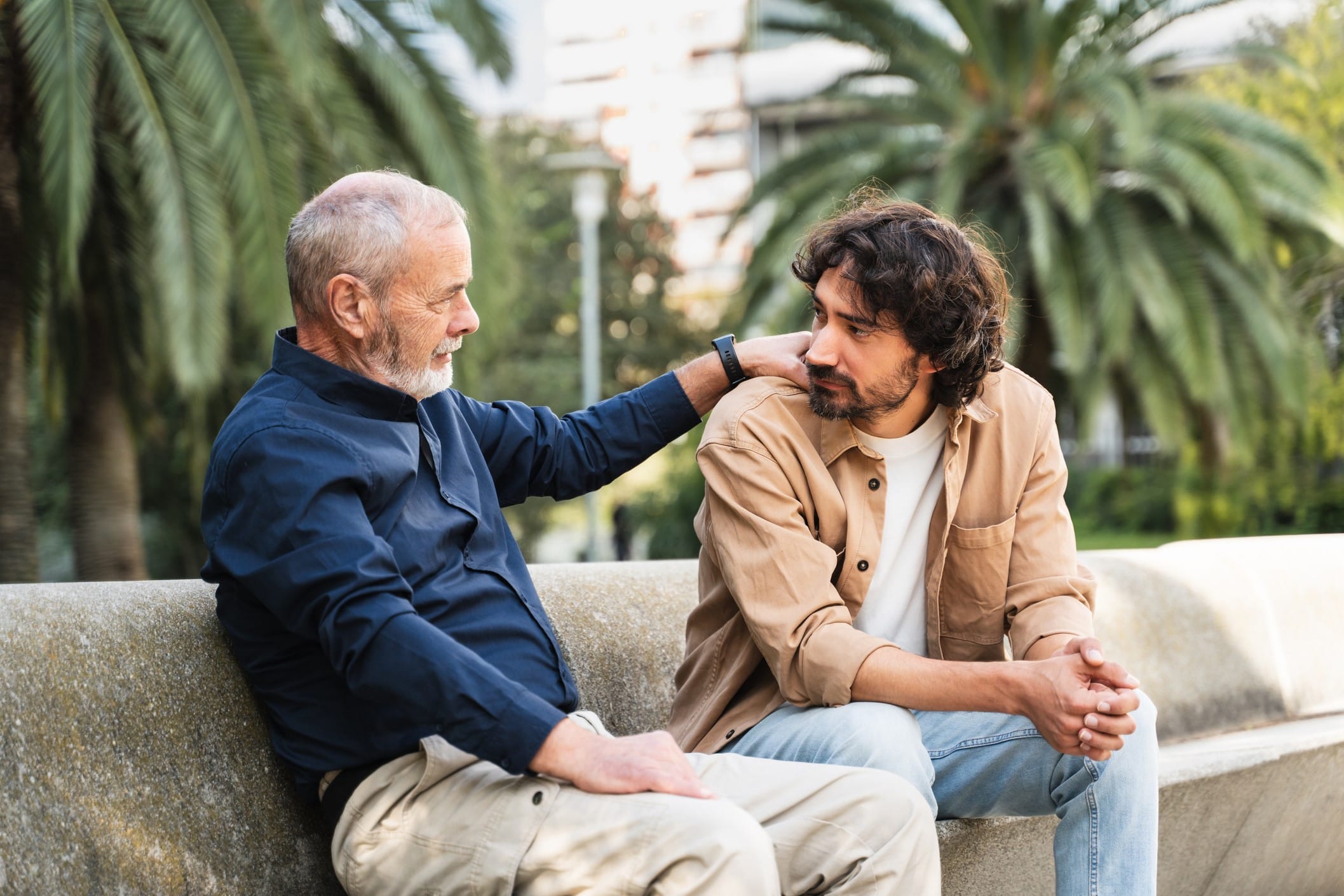 Father comforting adult son