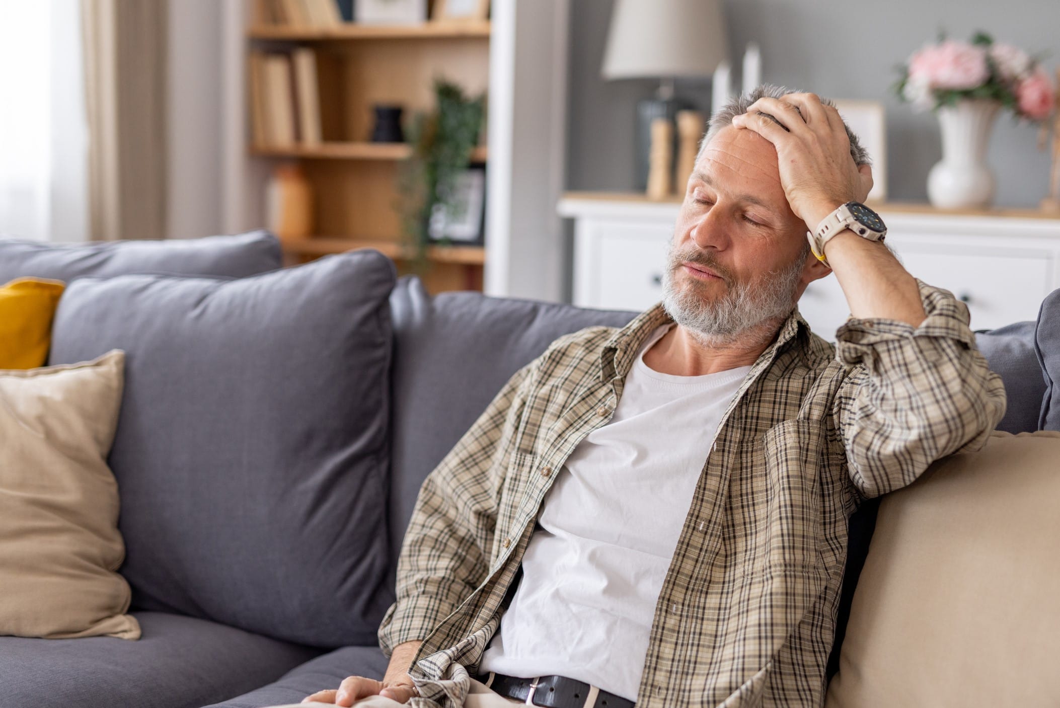 Tired man sitting on couch